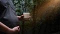 Pregnant woman held on the glass of milk.