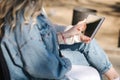 Pregnant woman with her best friend sitting in the park and looking for baby stroller using tablet. Two females in Royalty Free Stock Photo