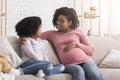 Pregnant Woman And Her Cute Daughter Spending Time Together At Home Royalty Free Stock Photo