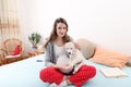 Pregnant woman with her dog at home Royalty Free Stock Photo