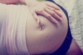 Pregnant woman with her hand on her belly