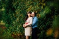 Pregnant woman and her handsome husband lovely hugging on nature, have picnic in park. Royalty Free Stock Photo