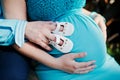 Pregnant woman and her husband holding hands on tummy with girls Royalty Free Stock Photo