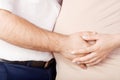 Pregnant woman and her husband holding making heart shape with hands on pregnant belly Royalty Free Stock Photo