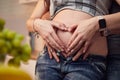 Pregnant woman and her husband hugging on the tummy together Royalty Free Stock Photo