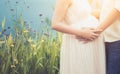 Pregnant woman and her husband hugging on the tummy together Royalty Free Stock Photo