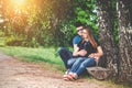Pregnant woman and her husband on park bench