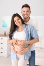 Pregnant woman and her husband showing heart
