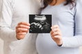 Pregnant woman and her husband showing ultrasound scan of their baby Royalty Free Stock Photo