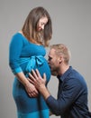 Pregnant Woman and her Man kissing the Belly Royalty Free Stock Photo