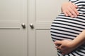 Pregnant woman holdig hands on belly, closeup. Pregnant woman's belly. Baby expectation