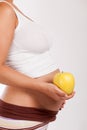 Pregnant woman holding a apple