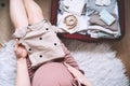 Pregnant woman holding baby bodysuit and packing maternity hospital bag. Beautiful mother during pregnancy waiting for baby Royalty Free Stock Photo