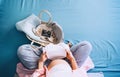 Pregnant woman holding baby bodysuit preparing to child birth during pregnancy. Mother with wicker basket with stuff for baby and Royalty Free Stock Photo