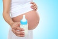 Pregnant Woman Holding Baby Bottle Royalty Free Stock Photo