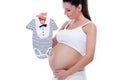 Pregnant woman holding baby clothes Royalty Free Stock Photo