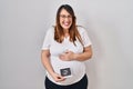 Pregnant woman holding baby ecography smiling and laughing hard out loud because funny crazy joke Royalty Free Stock Photo