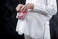 Pregnant woman holding baby girl shoes on her belly Royalty Free Stock Photo