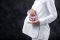 Pregnant woman holding baby girl shoes on her belly Royalty Free Stock Photo