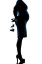Pregnant woman holding baby shoes Royalty Free Stock Photo