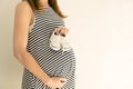 Pregnant woman holding baby shoes on her belly. Pregnancy and ba Royalty Free Stock Photo