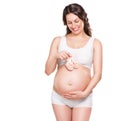 Pregnant woman holding baby shoes Royalty Free Stock Photo