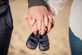 Pregnant woman holding baby shoes Royalty Free Stock Photo