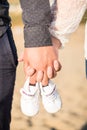 Pregnant woman holding baby shoes Royalty Free Stock Photo