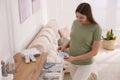 Pregnant woman holding baby socks at home Royalty Free Stock Photo