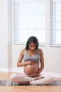 Pregnant woman holding belly at home while pregnant Royalty Free Stock Photo