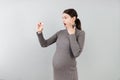 Pregnant woman holding a bottle of pills against her belly at colorful background with copy space. Taking medication during Royalty Free Stock Photo