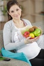 pregnant woman holding bowl fruit Royalty Free Stock Photo