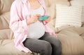 Pregnant woman holding box with pills at home, closeup Royalty Free Stock Photo