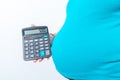 Pregnant woman holding calculator expenditure figures show isolated on white background Royalty Free Stock Photo