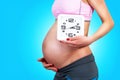 Pregnant woman holding clock Royalty Free Stock Photo