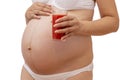 Pregnant woman holding cold glass of tomato juice at her tummy Royalty Free Stock Photo