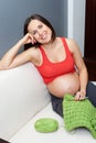 Pregnant woman holding crocheting