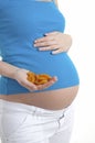 Pregnant woman holding dried apricots