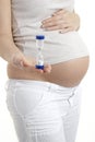 Pregnant woman holding egg timer Royalty Free Stock Photo