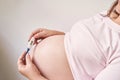 Pregnant woman holding fever thermometer. Flu treatment. People body. Sick Royalty Free Stock Photo