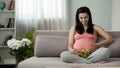 Pregnant woman holding fresh salad, accustoming future child to healthy food Royalty Free Stock Photo