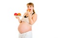 Pregnant woman holding fruits and eating apple Royalty Free Stock Photo