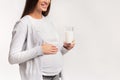 Pregnant Woman Holding Glass Of Milk Standing Over Pink Background Royalty Free Stock Photo