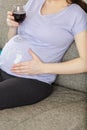 pregnant woman holding glass wine