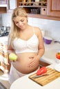 Pregnant woman holding green Apple and smiling Royalty Free Stock Photo