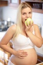 Pregnant woman holding green Apple and smiling Royalty Free Stock Photo