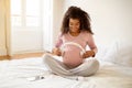 Pregnant Woman Holding Headphones Near Belly, Playing Melody To Baby In Womb Royalty Free Stock Photo