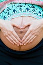 A pregnant woman holding her baby bump Royalty Free Stock Photo
