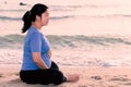 Pregnant woman holding her belly on the beach with copy space in Royalty Free Stock Photo