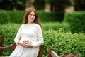 Pregnant woman holding a letter from plastic